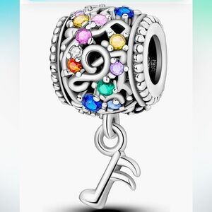 Music lovers note barrel style slide charm with a dangling music note st…